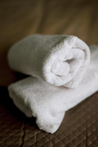 a stack of white towels sitting on a table at Blue Horizon Corinth in Korinthos