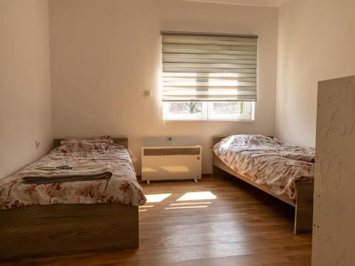 a bedroom with two beds and a window at Villa Mia in Sarajevo