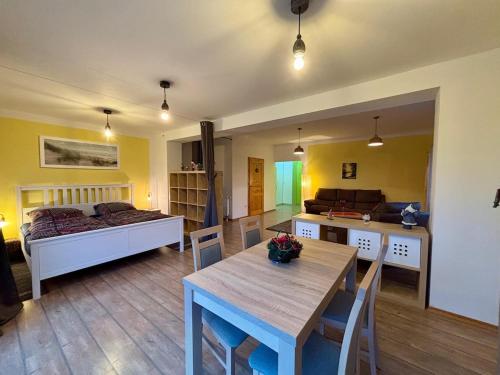 a room with a bed and a table and a bedroom at Zum Langschläfer in Fredersdorf