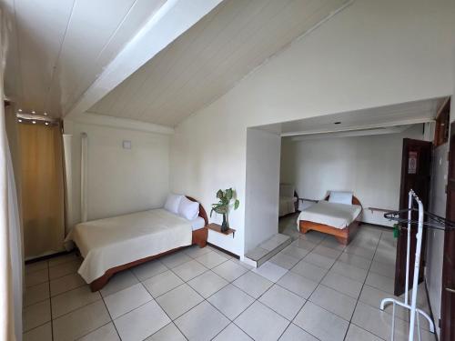 a bedroom with a bed and a couch in a room at Fortuna garden hotel in Fortuna