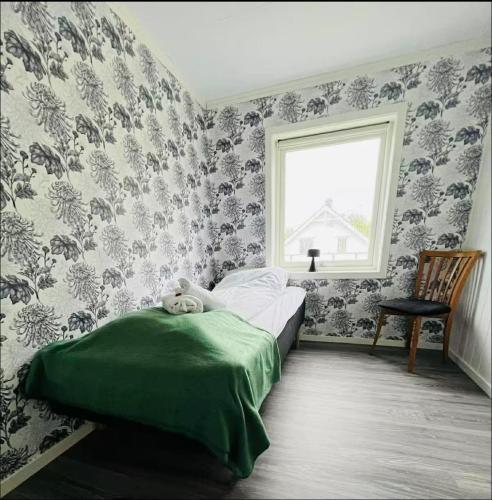 a bedroom with a bed with a teddy bear on it at Sivi`s hus in Moskenes