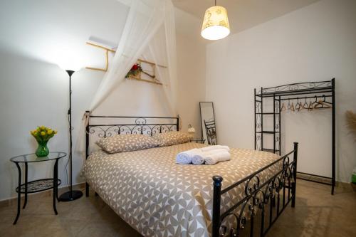 a bedroom with a bed with two towels on it at Il trullo di Memarì in La Correggia