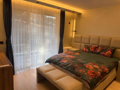 a bedroom with a bed and a large window at Forest Panorama Luxury Apartment in Velingrad