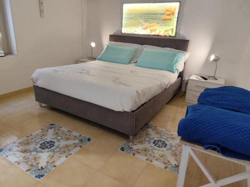 a bedroom with a bed and a painting on the wall at L'altra opera in Palermo