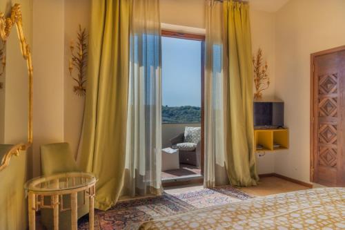 a bedroom with a bed and a sliding glass door at I Casciani in Montespertoli