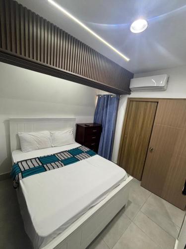 a bedroom with a large white bed in a room at The Perfect Place to be in Boca Chica