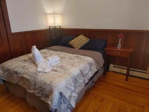 a bedroom with a bed with towels on it at Nigam's Sweet Home in Saint John