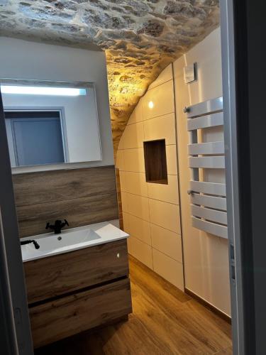 a bathroom with a sink and a mirror at La Terrette in Vagnas