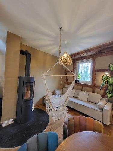 a living room with a hammock in a room at Kleine Oase in Ettenheim