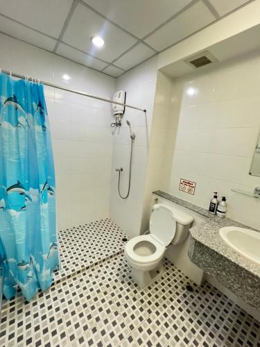 a bathroom with a toilet and a shower and a sink at Bts studio rooms in Bangna
