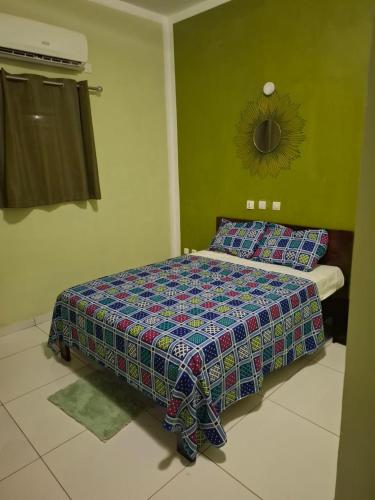 a bedroom with a bed in a room at Complexe Hôtelier Lassavane in Jacqueville
