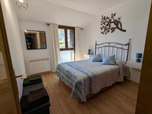 a bedroom with a bed and a window at Apartamento Asueto Ordesa in Broto
