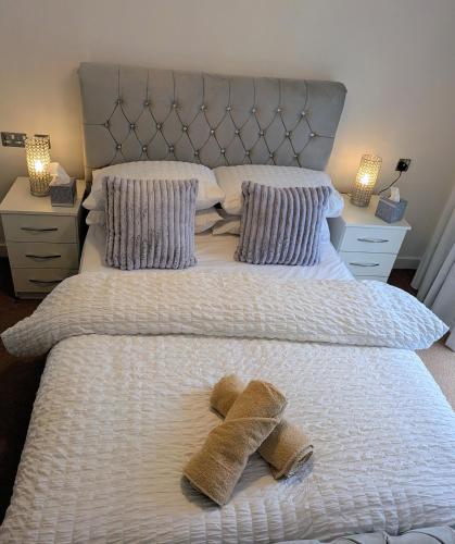 a bed with two teddy bears on top of it at Neptune 27 in Swansea