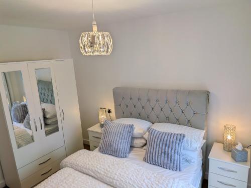 a bedroom with a bed and a mirror at Neptune 27 in Swansea