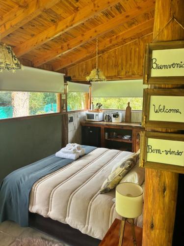 a bedroom with a large bed in a kitchen at Cabañas monoambiente La Generosa LP in Lago Puelo