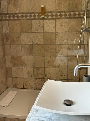 a bathroom with a sink and a shower at La Bastide de Vallon in Vallon-Pont-dʼArc