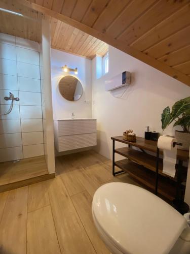 a bathroom with a white toilet and a shower at Pension Harmony in Bešeňová