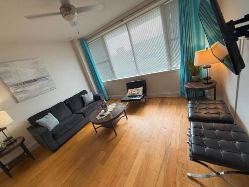 a living room with a couch and a coffee table at Beautiful Walk to French Quarter, Pool, Gym, View in New Orleans