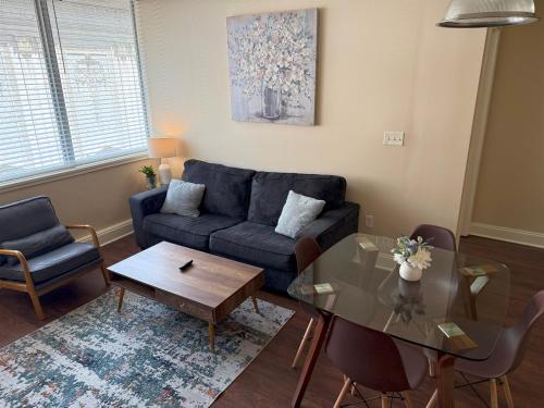 a living room with a couch and a table at Beautiful Walk to French Quarter, Pool, Gym, View in New Orleans