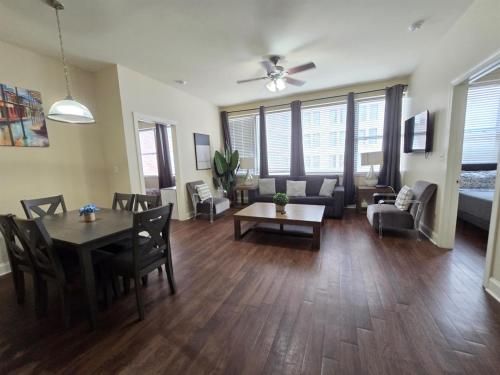 a living room with a table and chairs and a couch at Beautiful Walk to French Quarter, Pool, Gym, View in New Orleans