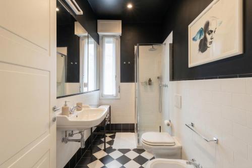 a bathroom with a sink and a toilet and a shower at Green House Historic Centre in Bologna