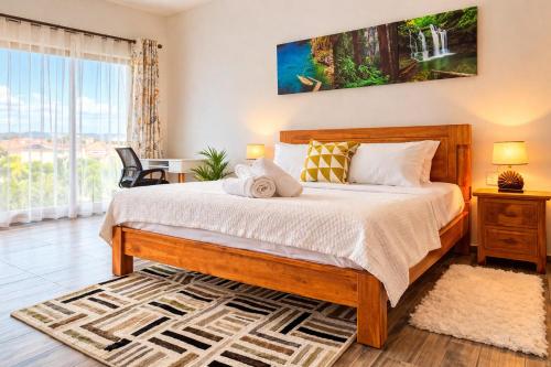 a bedroom with a bed and a large window at Hill Venue in Coquinbourg