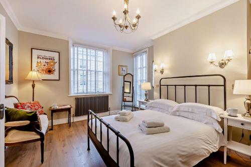 a bedroom with a large bed with towels on it at Swan House in Southport