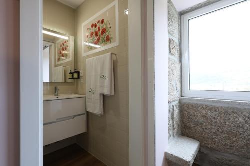 a bathroom with a sink and a window at Quinta do Giz in Baião