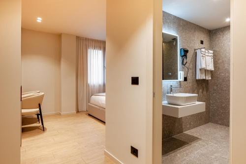 a bathroom with a sink and a bed at Hotel Pusi in Sauk