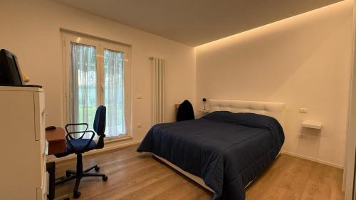 a bedroom with a bed and a desk and a window at Ulivo sereno in Giulianova