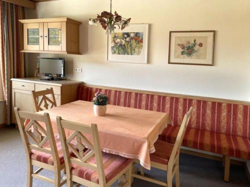 a kitchen with a table and chairs and a television at Chalet Cristall Superior Appartement 3 in Leutasch