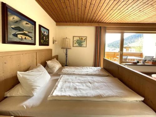two beds in a room with a window at Chalet Cristall Superior Appartement 3 in Leutasch