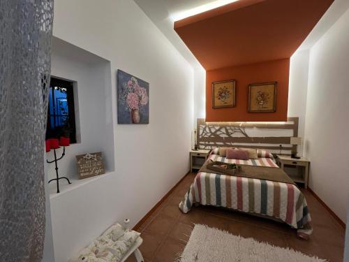a bedroom with a bed and orange walls at Salamandra in Carboneras