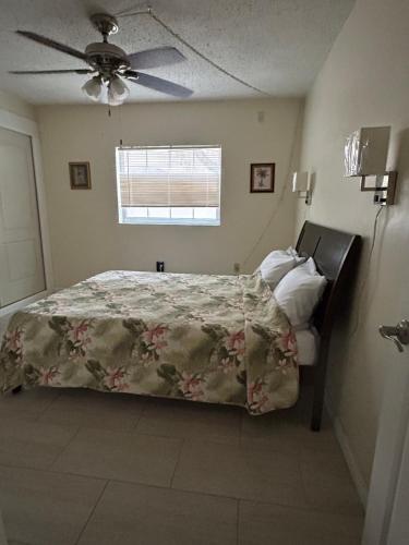 a bedroom with a bed and a ceiling fan at Clearwater Beach Getaway Clearwater in Clearwater