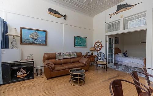 a living room with a couch and a bed at Bisbee Grand Hotel, Saloon, and Music Venue in Bisbee