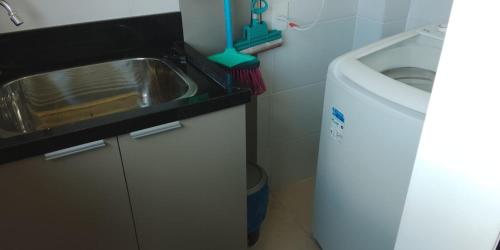 a small bathroom with a sink and a toilet at Edifício Capri , apto 405 Canela RS in Canela