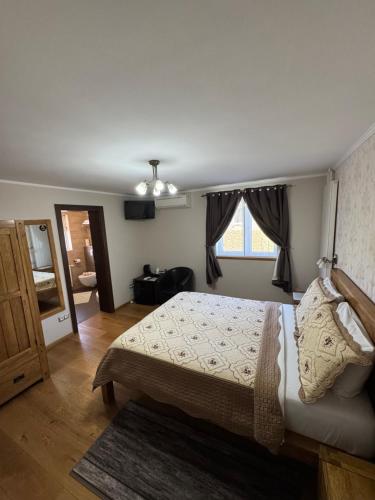 a bedroom with a large bed and a window at B&B Millenium House 2 in Jezerce