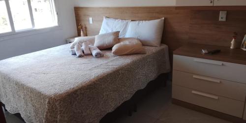 a bedroom with a bed with two towels on it at Edifício Capri , apto 405 Canela RS in Canela