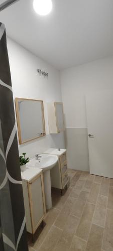 a bathroom with two sinks and a mirror at Atico Queen Itimad in San Juan de Aznalfarache