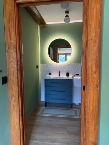 a bathroom with a blue sink and a mirror at El Sueño de Celia 1 in Doña Juandi