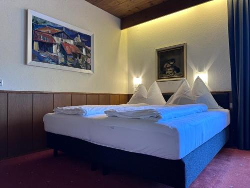 a bedroom with a large bed with blue sheets and pillows at Chalet Cristall Superior Appartement 10 in Leutasch