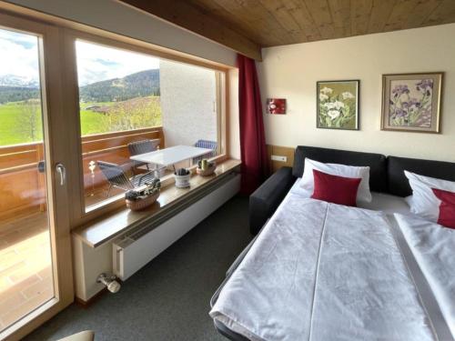 a bedroom with a bed and a large window at Chalet Cristall Superior Appartement 9 in Leutasch