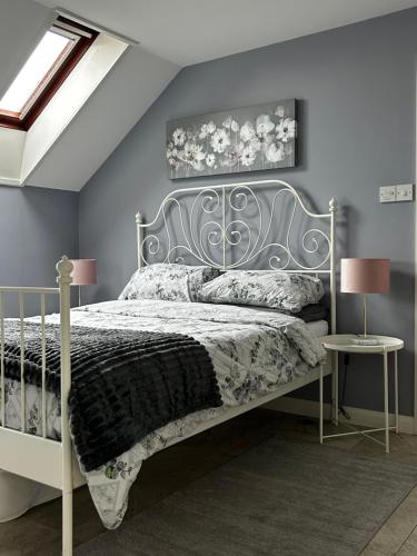 a bedroom with a bed with a metal headboard at Lilyscape At Whitehead in Whitehead