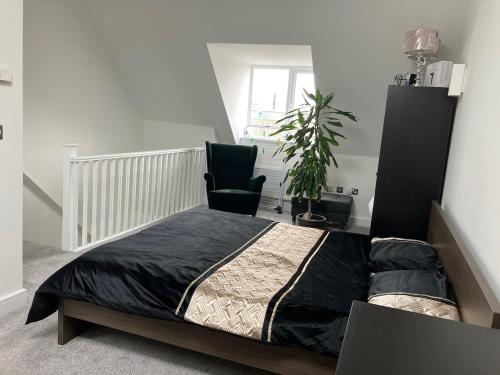 a bedroom with a bed and a chair at Waverley 3-Bed Springfields House in Rotherham