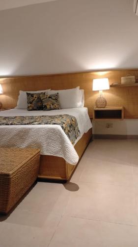 a bedroom with a bed with a lamp on it at 31 Exclusive Cabin with Private Jacuzzi, Beach in Tubará