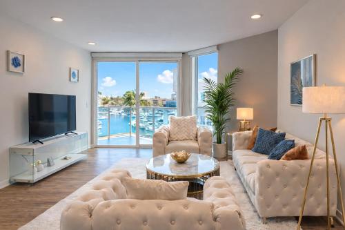 a living room with a couch and a tv at Venice Marina Water Front Luxury Condo in Los Angeles