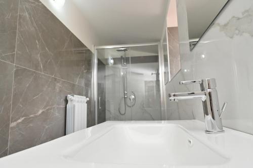 a bathroom with a shower and a sink with a faucet at FarmVille B&B in Moliterno