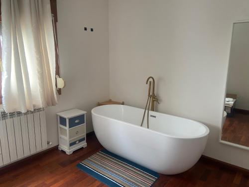 a white bath tub sitting in a room at Refugio de ensueño in Sabiñánigo