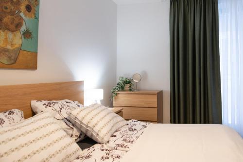 a bedroom with a bed with white sheets and pillows at Rotunda 309 in Dunajská Streda