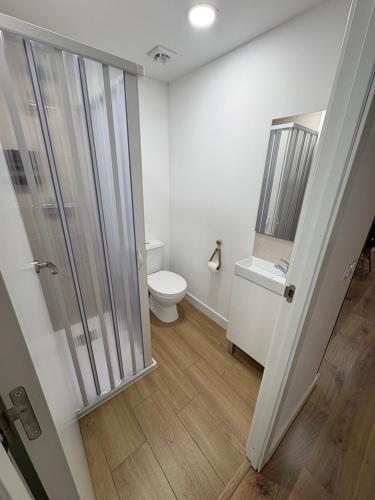a bathroom with a toilet and a glass shower at Alma in La Canyera